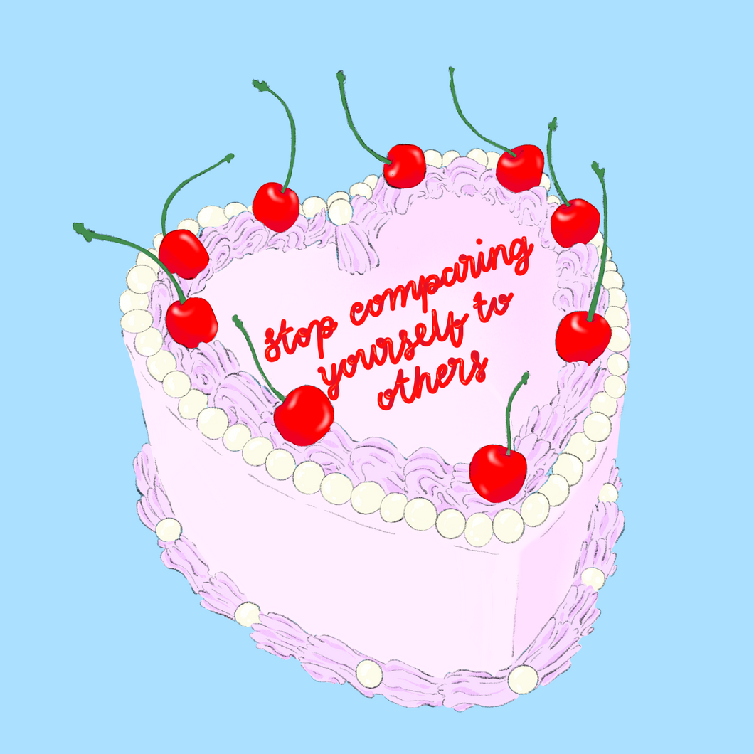 decorative pink cake with cherries on top, with 'stop comparing yourself to others' written in red icing